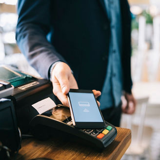Man paying with smartphone using NFC.