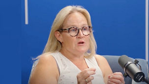 Podcast guest speaking into a microphone during a recording session