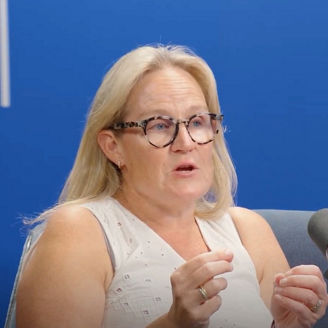 Podcast guest speaking into a microphone during a recording session