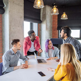 Coworkers laughing in team meeting