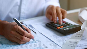 Man hand filling US tax form. tax form us business income office Financial document. Tax time.Tax concept. Close-up.