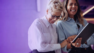 Two smiling women with Ipad