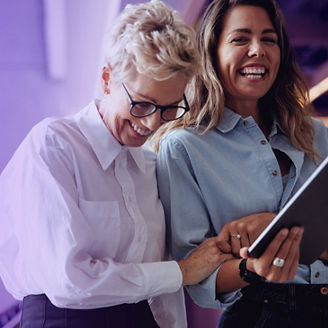Two smiling women with Ipad