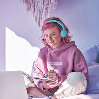 girl in pink sweatshirt working on laptop