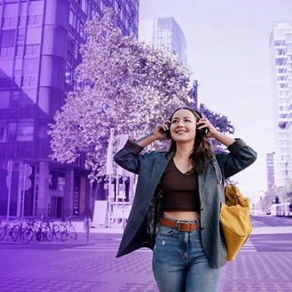 Woman taking of headphones while walking