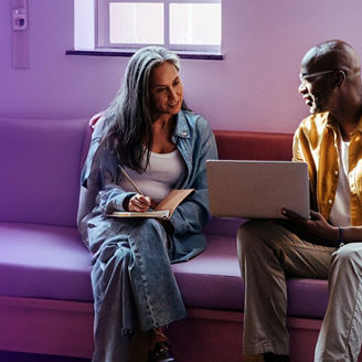 Women and a men looking at a laptop