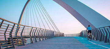 Cyclist riding on suspension bridge