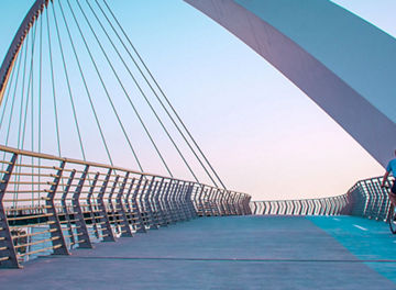 Cyclist riding on suspension bridge