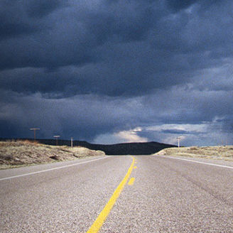 Dark clouds above empty road banner