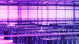 Data Center Female System Administrator and Male IT Specialist Talk, Use Laptop. Information Technology Engineers work on Cyber Security Network Protection in Cloud Computing Server Farm.