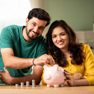 Indian asian young couple and saving concept using coins and piggy bank at home