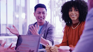 Man and woman smiling in a meeting