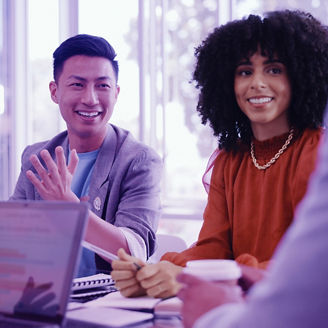 Man and woman smiling in a meeting