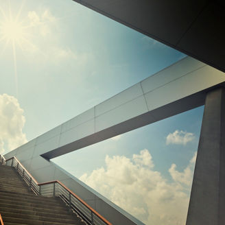concept shot of a modern architecture surrounding with a huge stairway into the light.
