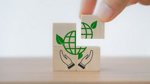 hand complete green globe icon on cube ,CSR, eco green sustainable living, zero waste, plastic free, earth day, world environment day, responsible consumption Social responsibility core value concept