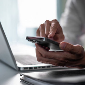 Close up of business man hand using smart phone and tablet. business and technology concept.