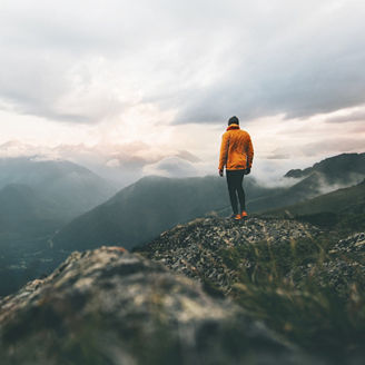 Man adventurer on mountain summit hiking Traveling alone heathy lifestyle active vacations trail running outdoor