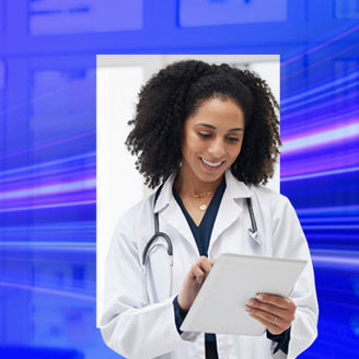 Doctor smiling looking at tablet