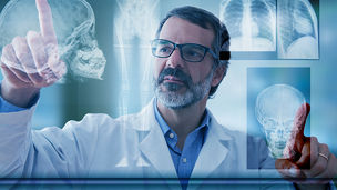 Doctor touching digital x-ray of skull