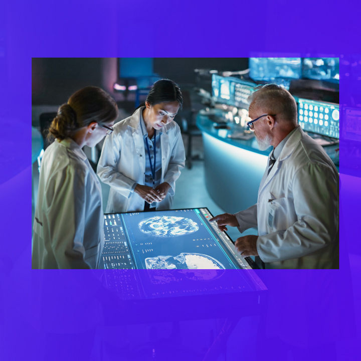 3 medical profesionals looking at digital brain scan on a table screen banner