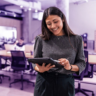 Vrouw met een laptop in haar handen op kantoor