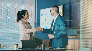 Four statues in front of buildings with blue sky above