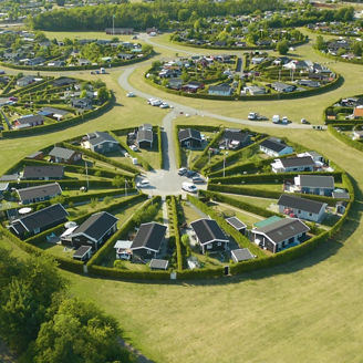 Drone view of houses in meadow