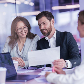 Collegues in a business meeting looking at sheet