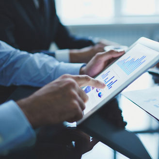 Image of businessperson pointing at document in touchpad at meeting