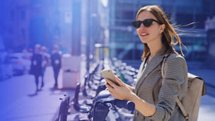 Woman with sunglasses holding phone