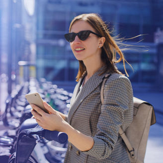Woman with sunglasses holding phone