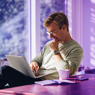man smiling at laptop