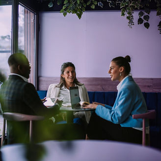 Colleagues talking to eachother with laptop