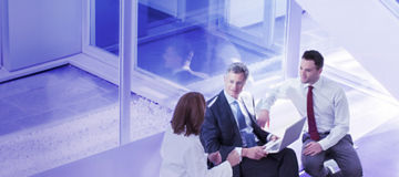 Nomination and Remuneration - people looking over glass balcony