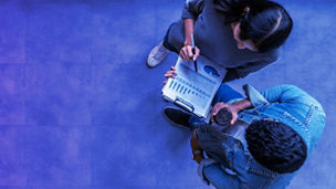 Banner of top view of young asian business team standing, talking and reporting with annual report document in modern workplace. Above view of casual creative team discussion with report performance.