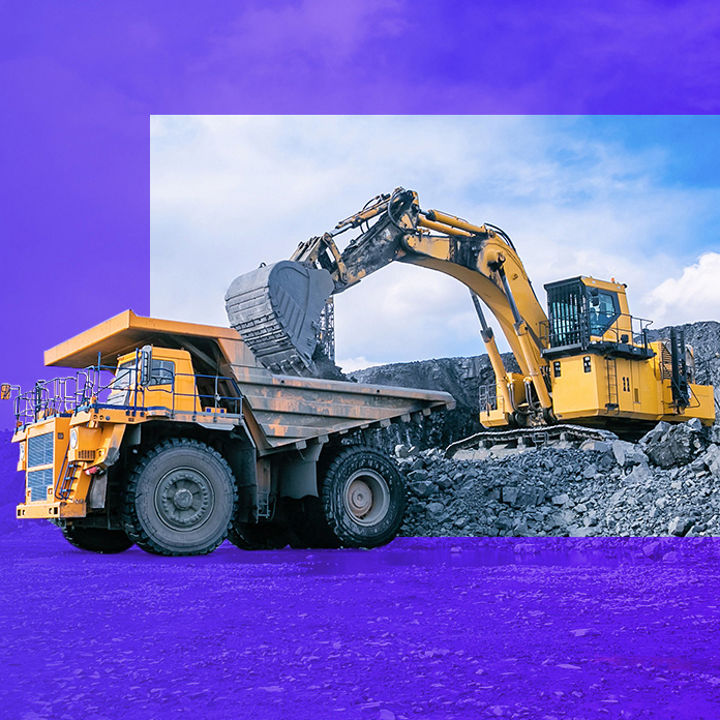 Mining excavator loading rocks in mining truck banner
