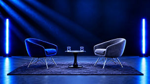 Two chairs and a table in a modern discussion space.