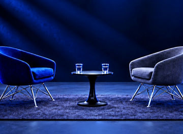 Two chairs and a table in a modern discussion space.