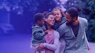 Family of four with parents carrying small children