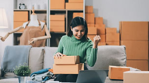 Asian SME business women use laptop computer checking customer order online shipping boxes at home. Starting Small business entrepreneur SME freelance. Online business, Work at home concept.