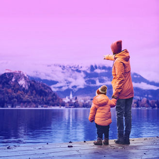 Father and Son Standing Near A Lake