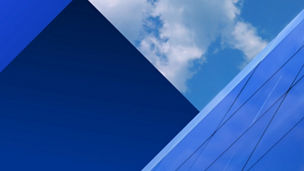 Federal Budget 2026 banner geometric banner showing buildings and clouds in a blue sky
