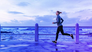 female runner in front of the sea