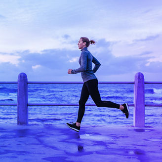 female runner in front of the sea