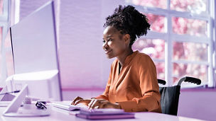 African American Black Woman Using Computer. Worker With Disability.