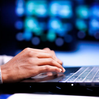 Close up shot of manager in server hub using laptop to set up configuration management tools that enable automatic failover and load balancing, preventing rackmounts data loss