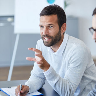 A portrait of a young smiling businessman  a meeting and presentation in the office. Business concept