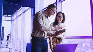 Man and woman discussing over laptop