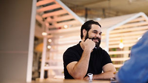 Man sitting at table meeting with woman