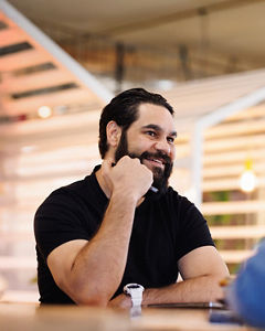 Man sitting at table meeting with woman